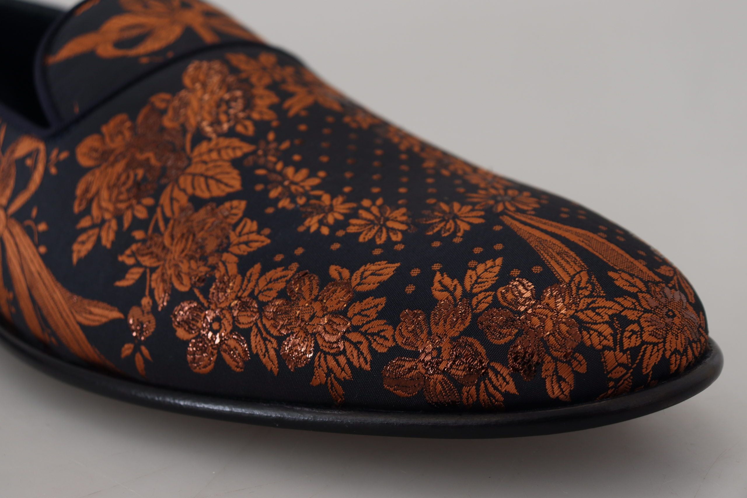 Experience the exquisite Dolce & Gabbana Blue Rust Floral Slippers, where luxurious materials meet Italian craftsmanship, elevating your style with effortless elegance.