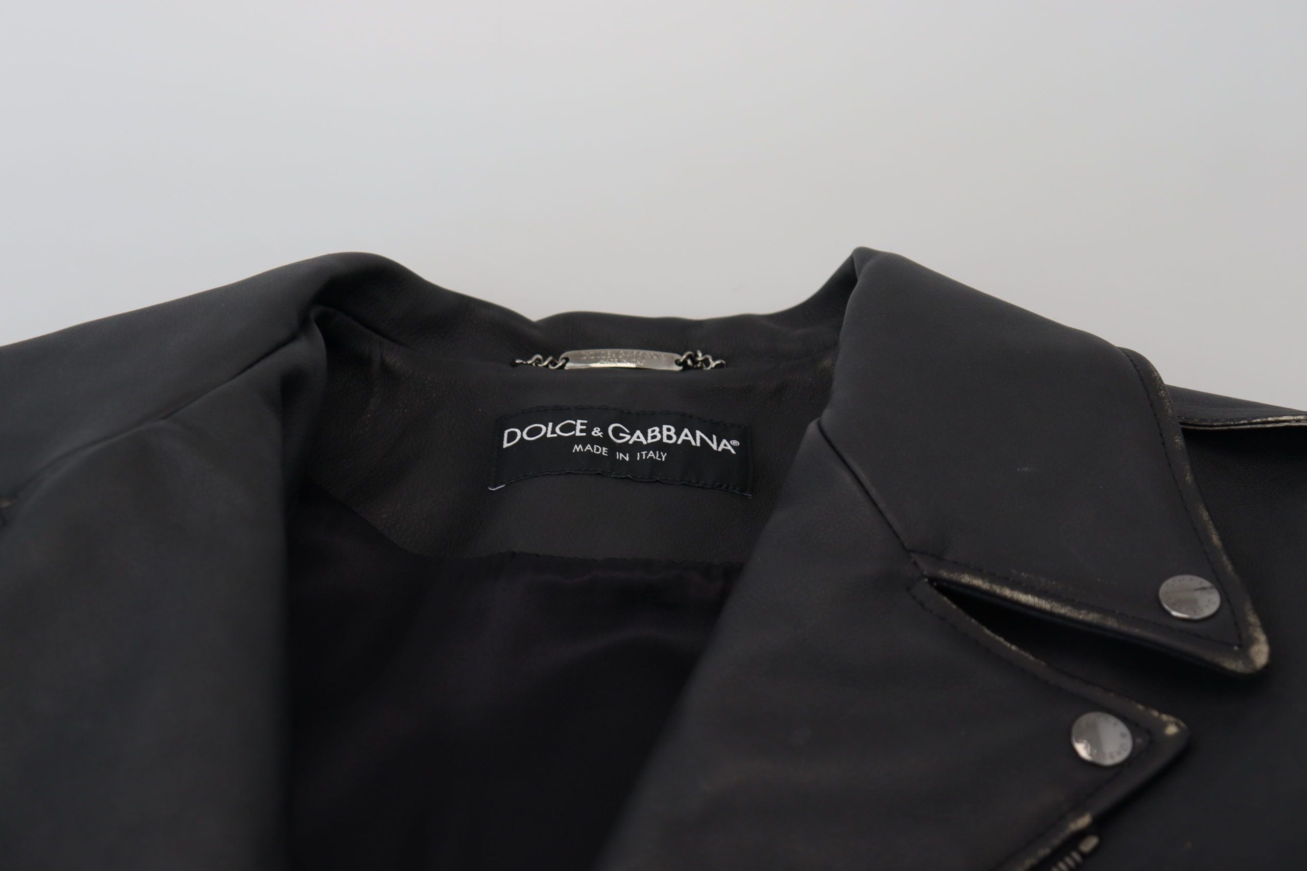 Indulge in the exquisite Dolce & Gabbana Black Leather Biker Coat, a timeless masterpiece crafted from premium leather, embodying elegance and sophistication for the discerning individual.