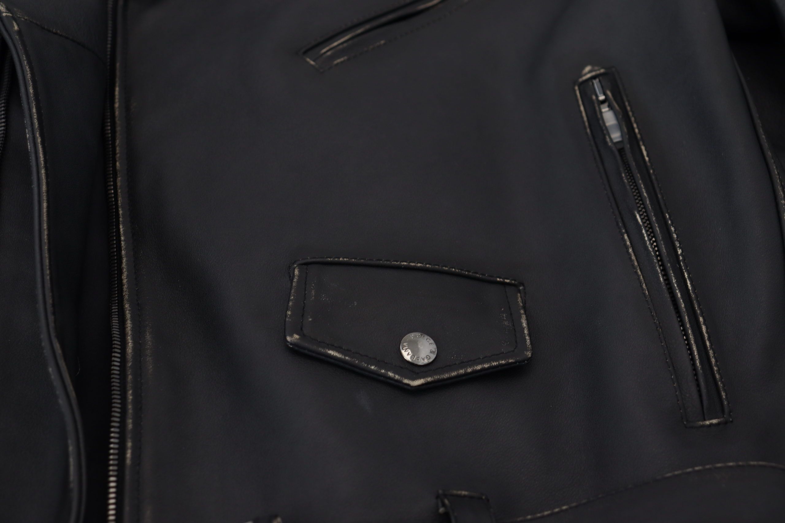 Indulge in the exquisite Dolce & Gabbana Black Leather Biker Coat, a timeless masterpiece of luxury craftsmanship that elevates your style and sophistication.