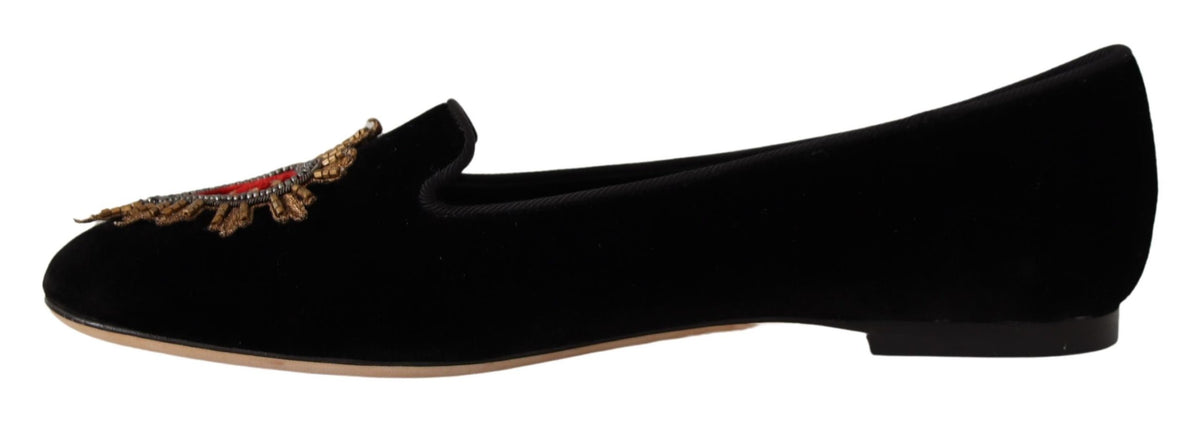 Elevate your style with Dolce & Gabbana's Black DG Sacred Heart Patch Slip On Flats, crafted from luxurious leather, embodying exquisite Italian craftsmanship and timeless elegance.