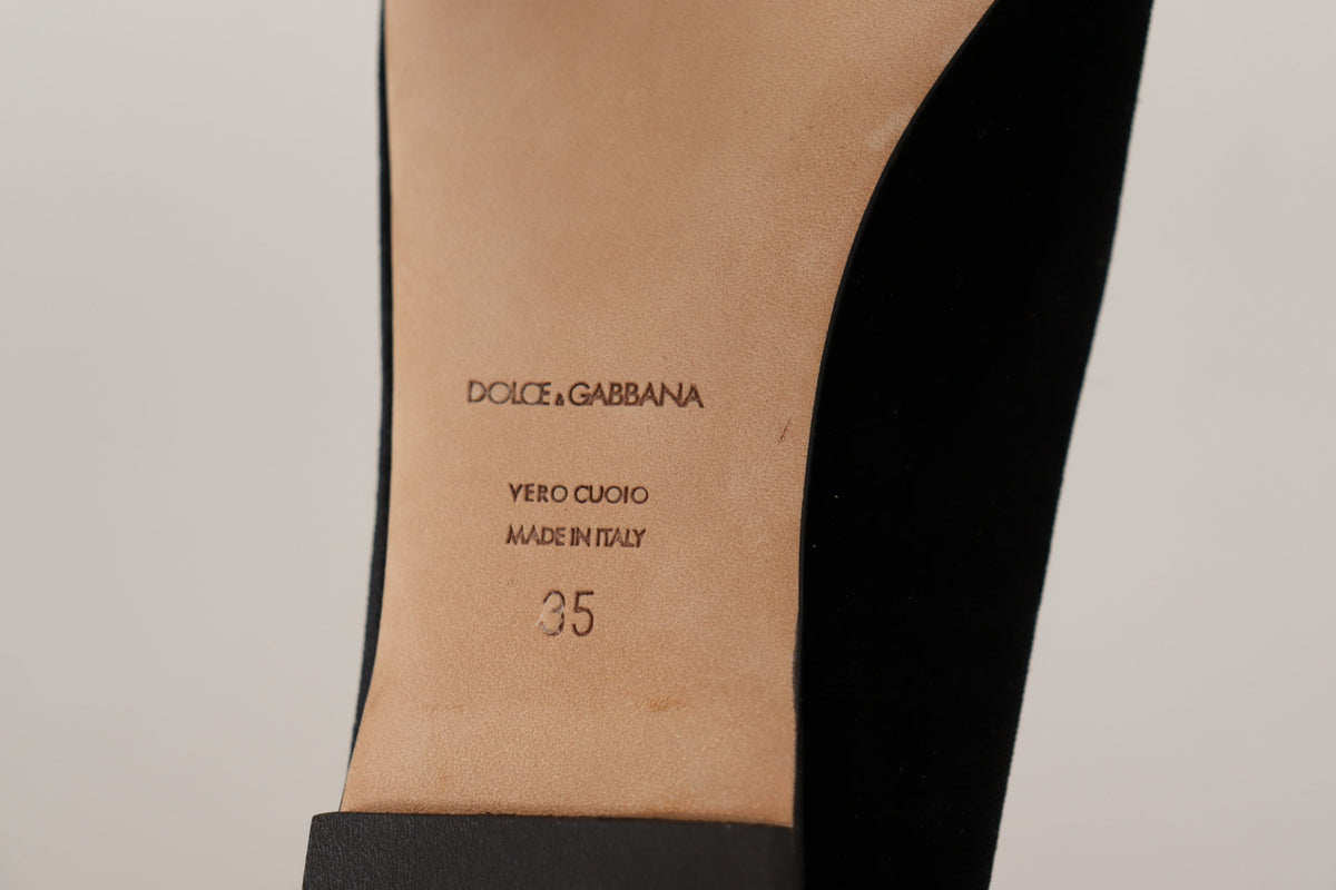Elevate your style with Dolce & Gabbana's Black DG Sacred Heart Patch Slip On Flats, crafted from luxurious leather, embodying exquisite Italian craftsmanship and timeless elegance.