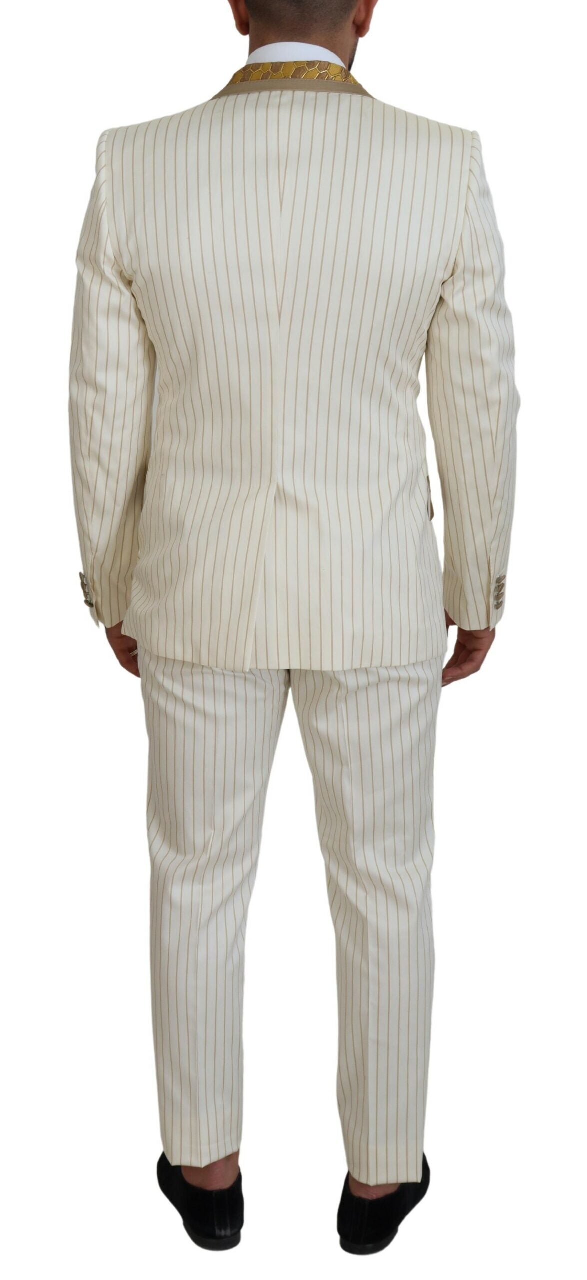 Elevate your wardrobe with the Dolce & Gabbana Off White Gold Striped Tuxedo Slim Fit Suit, a masterpiece of Italian craftsmanship designed for the discerning individual.