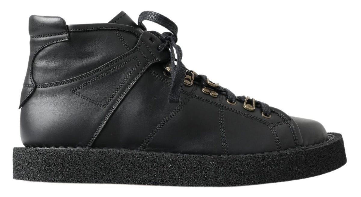 Experience the allure of Dolce & Gabbana's Black Leather Slip-on Stretch Boots, handcrafted in Italy for those who embody elegance and authority in every step.