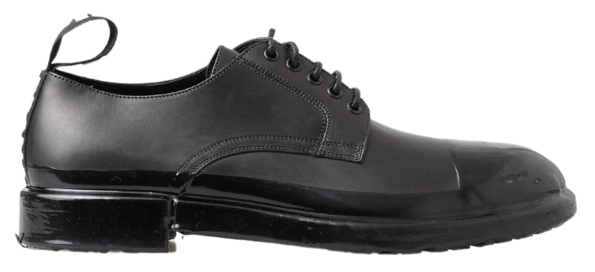 Step into a world of elegance with Dolce & Gabbana's Black Leather Derby Dress Shoes, where exquisite craftsmanship meets timeless luxury for the discerning individual.