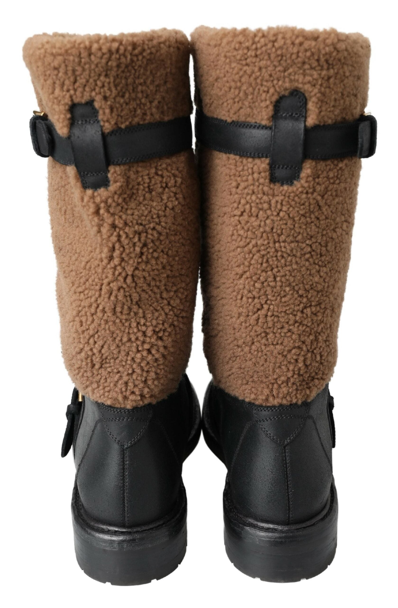 Indulge in the exquisite Dolce & Gabbana Black Leather Brown Shearling Boots, where unparalleled craftsmanship meets luxurious materials for a sophisticated winter style.