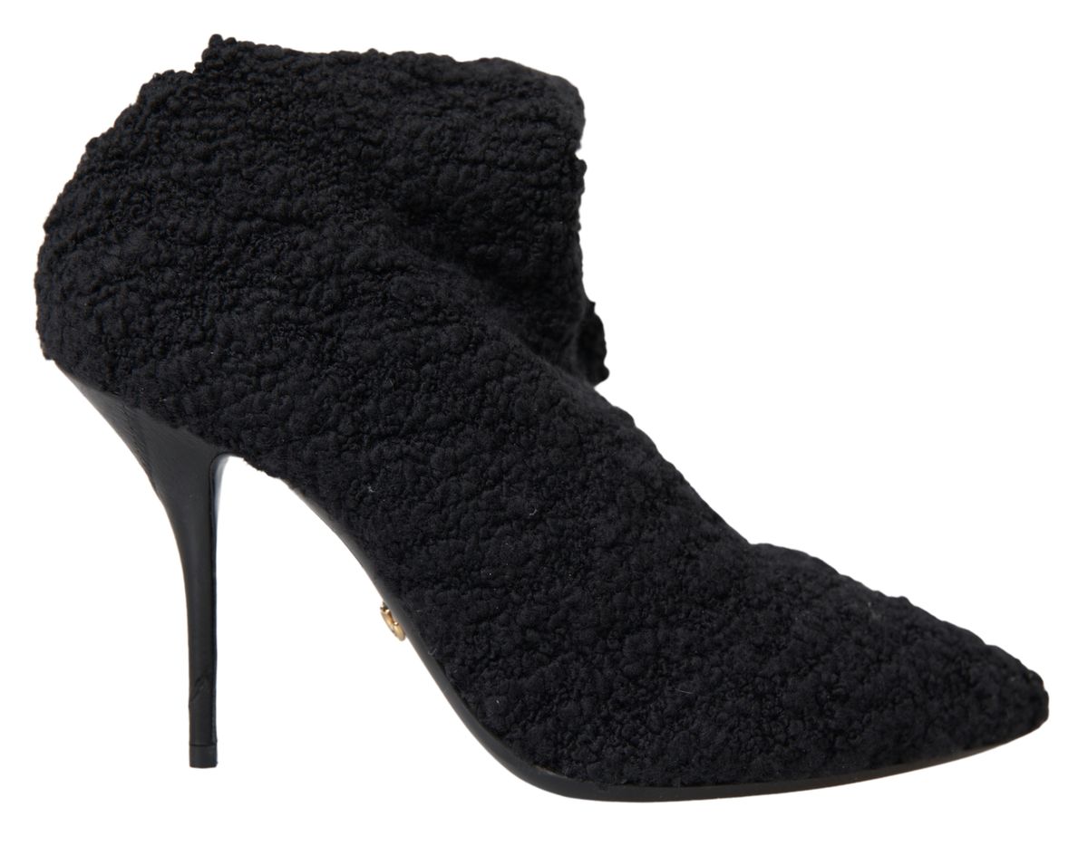 Step into the allure of Dolce & Gabbana's Black Stiletto Heels Mid Calf Boots, crafted from premium virgin wool, embodying timeless elegance and exquisite Italian craftsmanship.