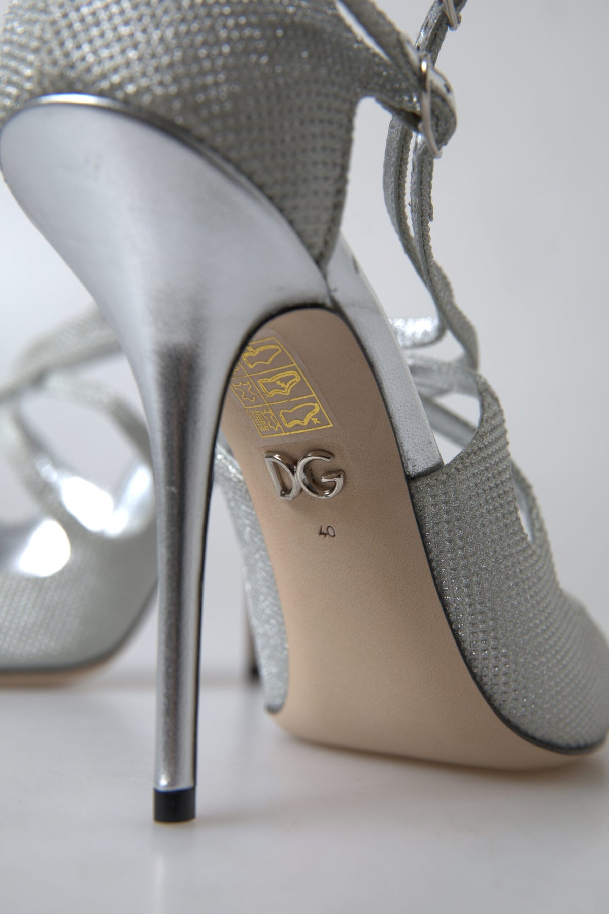 Step into unparalleled elegance with Dolce & Gabbana Silver Shimmers Sandals, crafted in Italy from luxurious materials, embodying timeless allure and sophistication.