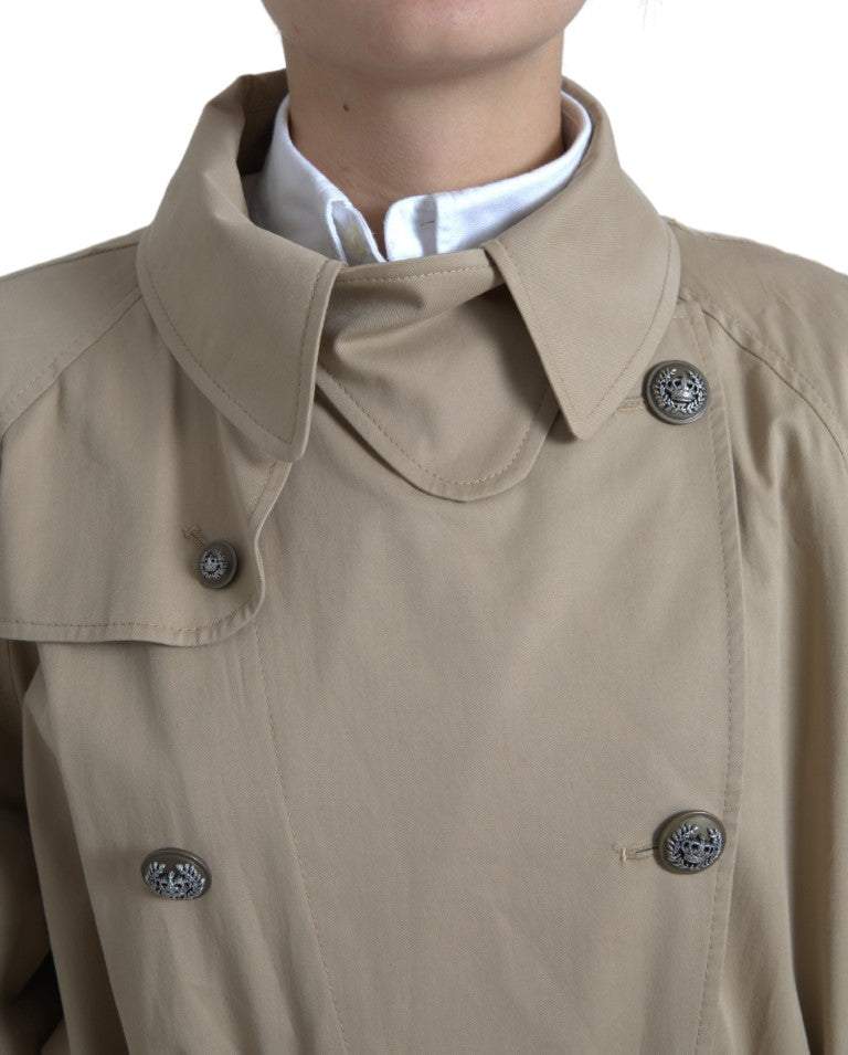 Discover the Dolce & Gabbana Khaki Double Breasted Trench Coat, a testament to Italian craftsmanship, blending luxurious cotton and elastane for timeless elegance.