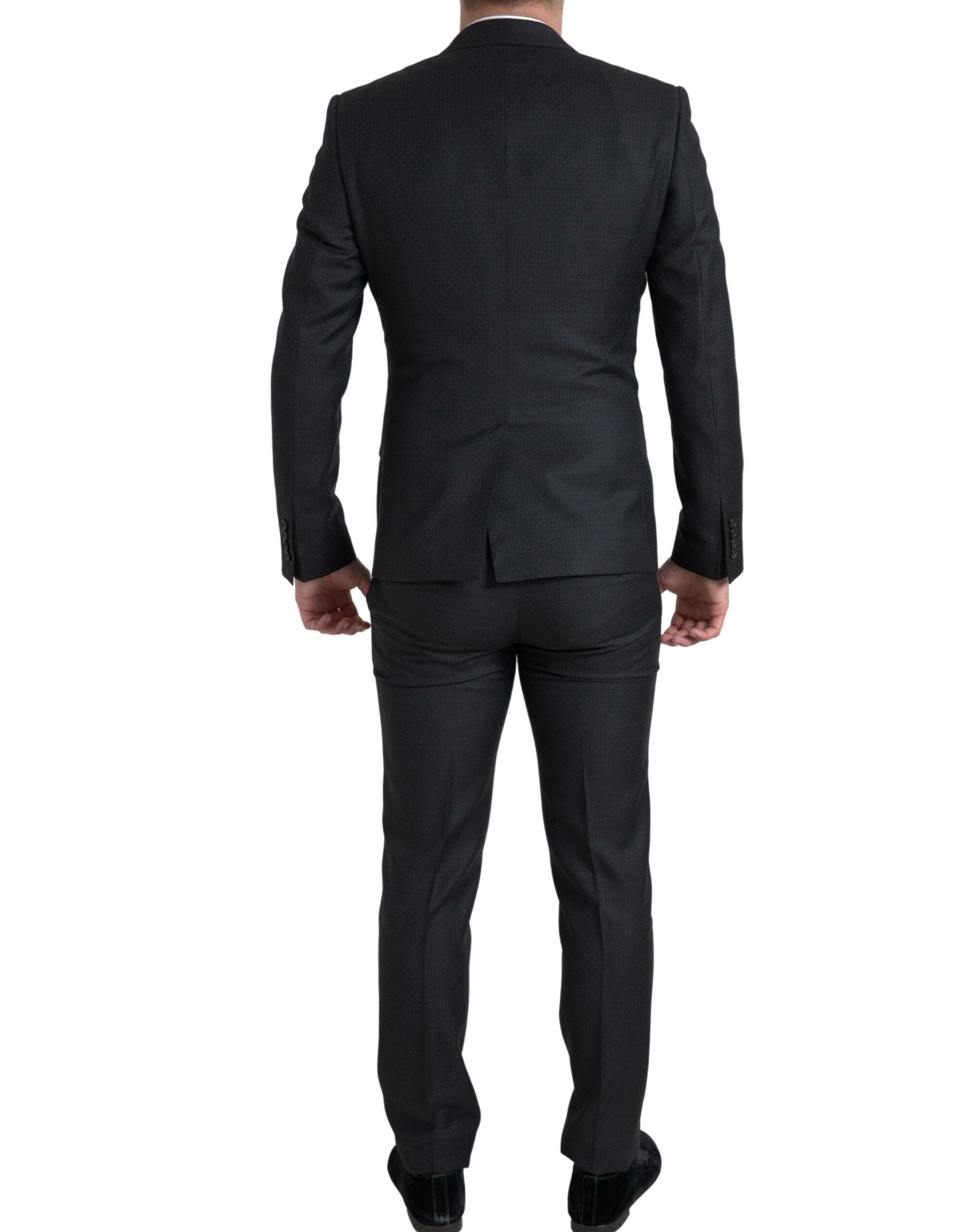 Discover the Dolce & Gabbana Black MARTINI Suit, crafted from luxurious virgin wool, embodying exquisite craftsmanship and timeless elegance for the discerning individual.