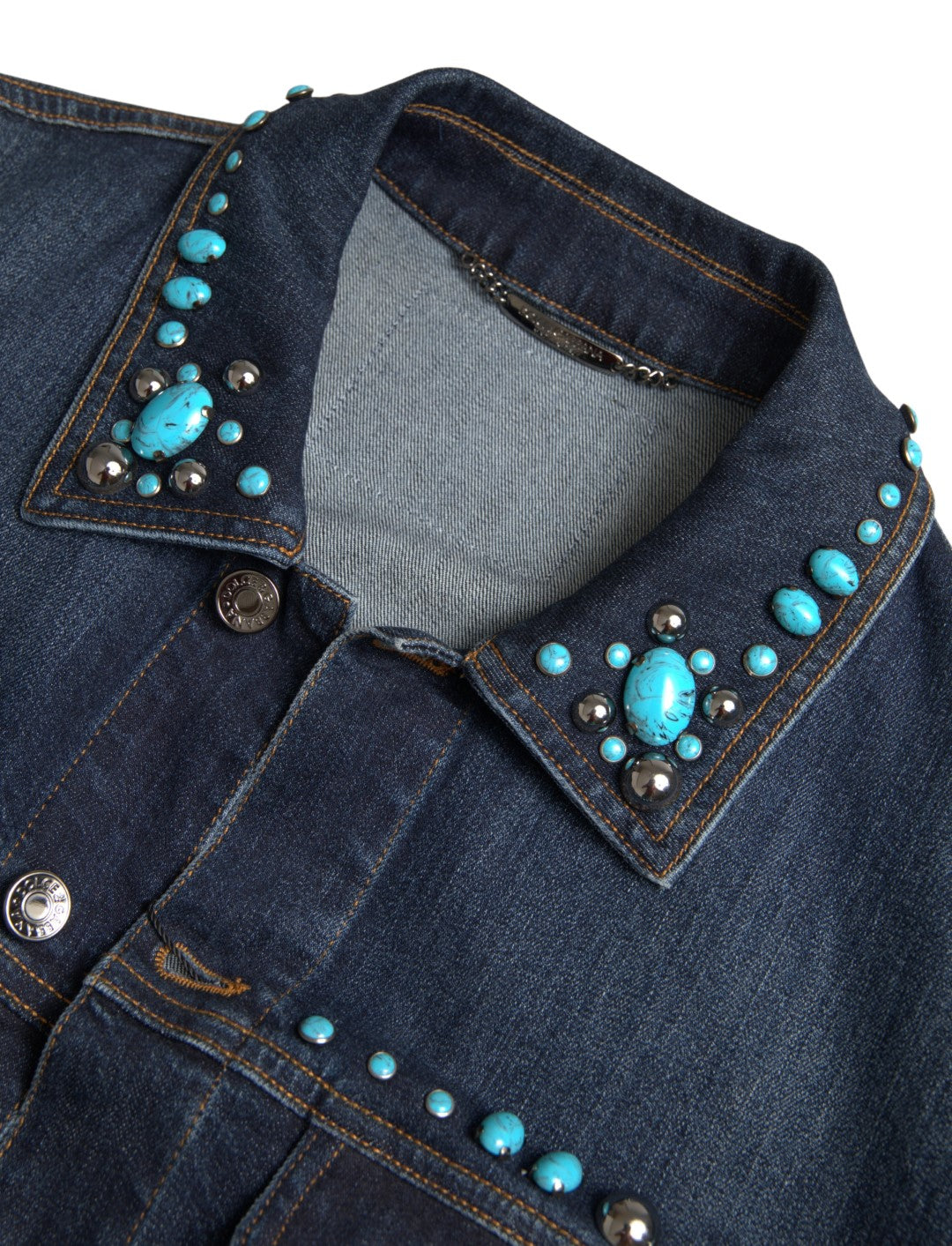 Experience the allure of Dolce & Gabbana's Blue Denim Turquoise Stones Studded Jacket, where exquisite craftsmanship meets timeless elegance, perfect for the discerning individual.
