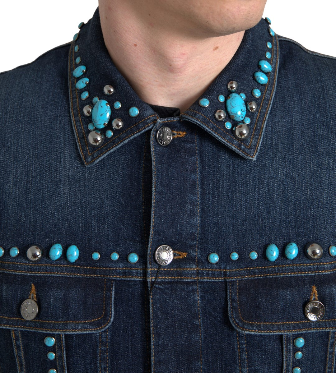 Indulge in the Dolce & Gabbana Blue Denim Turquoise Stones Studded Jacket, where exquisite craftsmanship meets timeless elegance, embodying luxury and individuality.