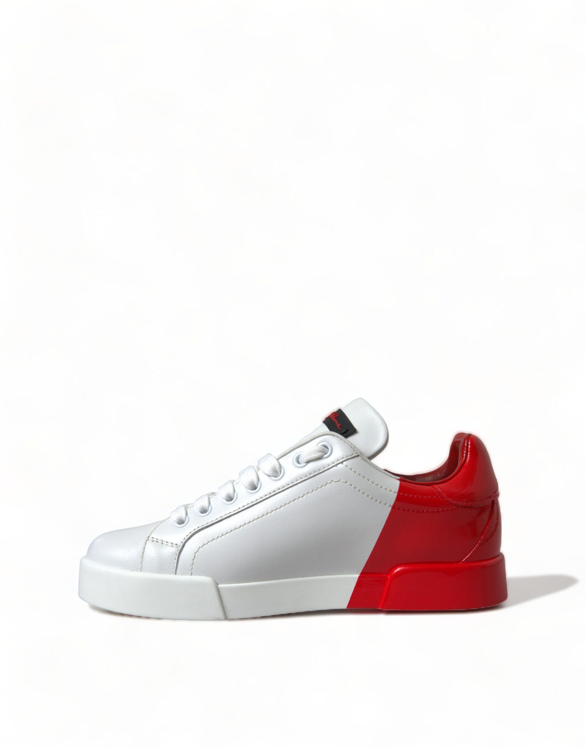 Step into a realm of elegance with Dolce & Gabbana's White Red Lace Up Women's Low Top Sneakers, crafted from luxurious leather in Italy, embodying timeless sophistication and unparalleled artistry.