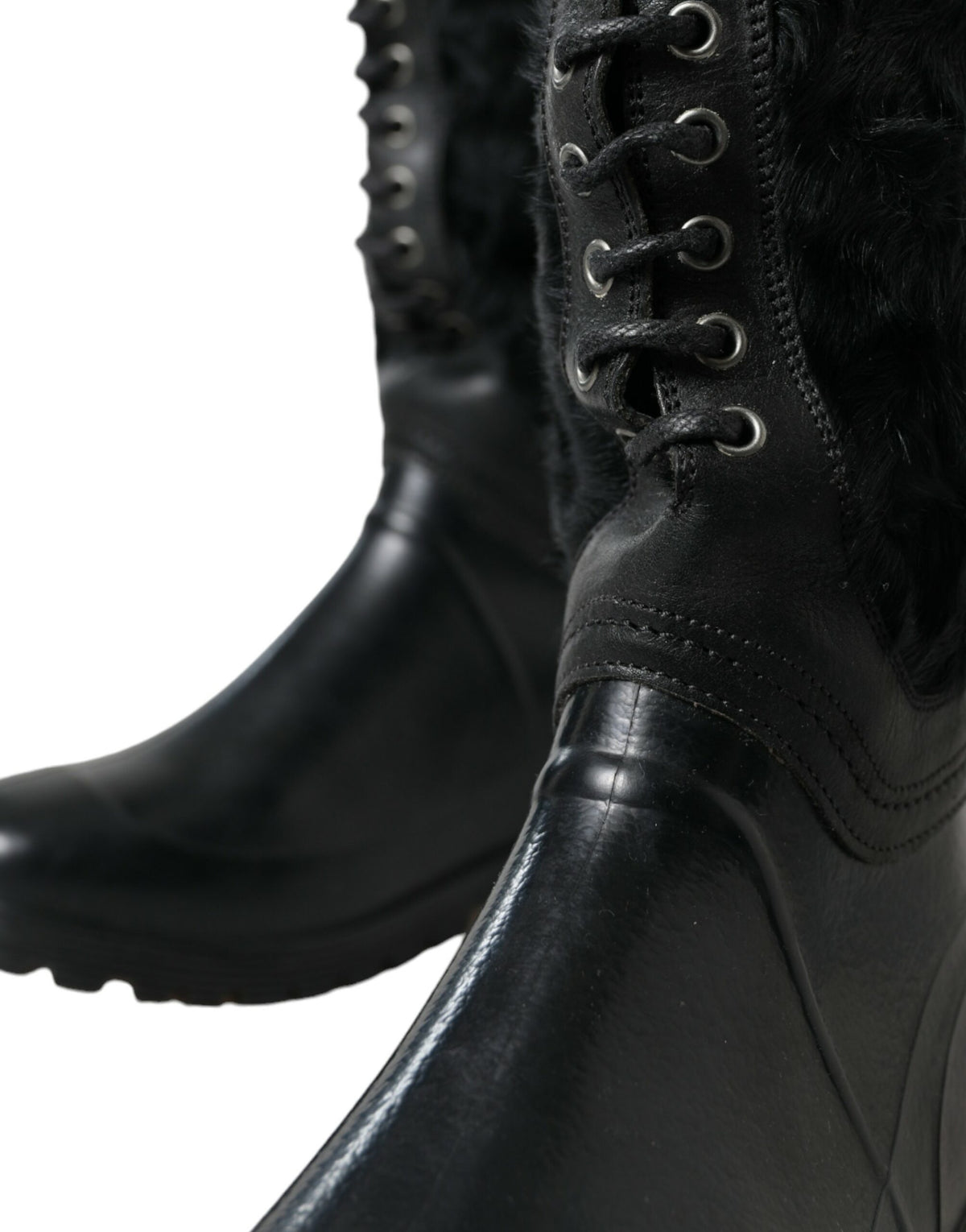 Step into the realm of luxury with Dolce & Gabbana's Black Rubber Lace Up Shearling Rain Boots, where exquisite craftsmanship meets contemporary elegance for the discerning individual.