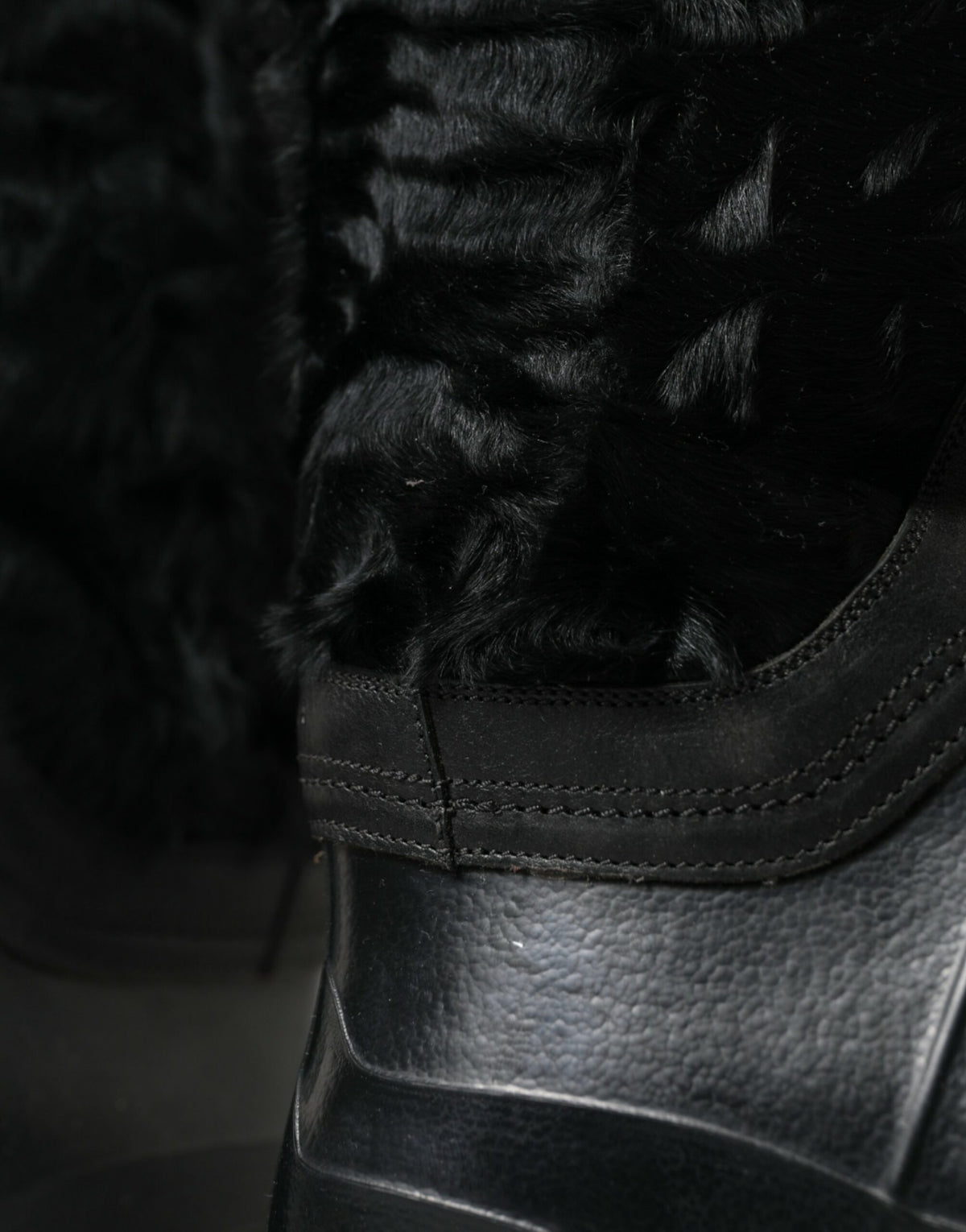 Indulge in the luxurious allure of Dolce & Gabbana's Black Rubber Lace Up Shearling Rain Boots, where exquisite craftsmanship meets contemporary elegance for the discerning individual.