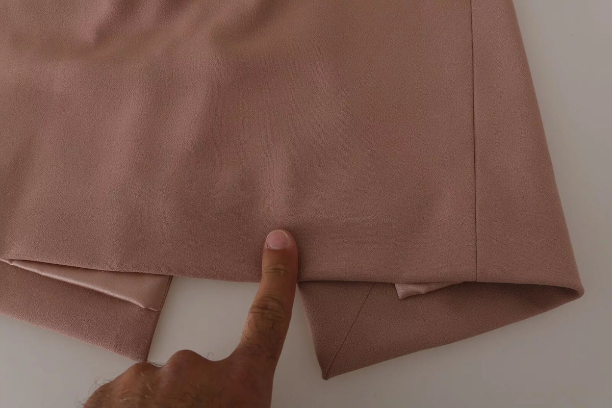 Indulge in the exquisite Dolce & Gabbana Dusty Pink Midi Sheath Dress, where luxurious silk and crystal buttons elevate your allure, embodying timeless elegance and sophistication.