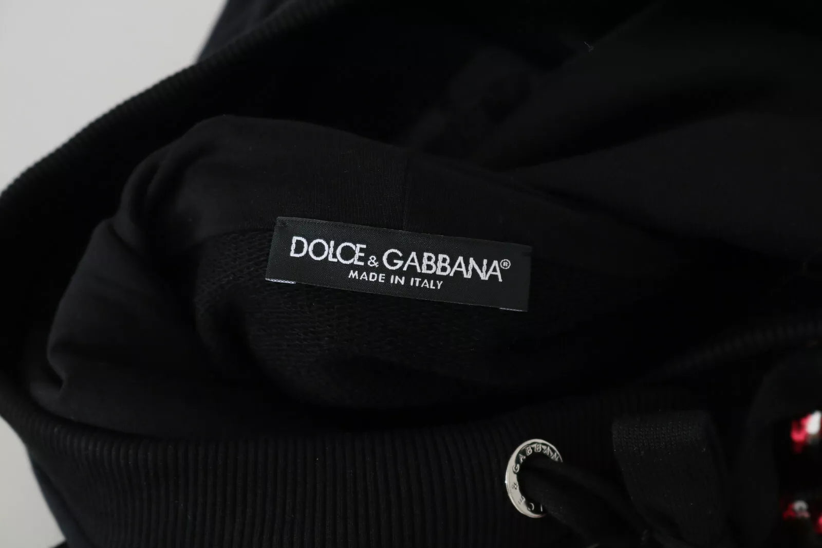 Indulge in the exquisite Dolce & Gabbana DG Sequined Hooded Pullover Sweater, a masterpiece of Italian craftsmanship, blending luxury and allure for the discerning wardrobe.