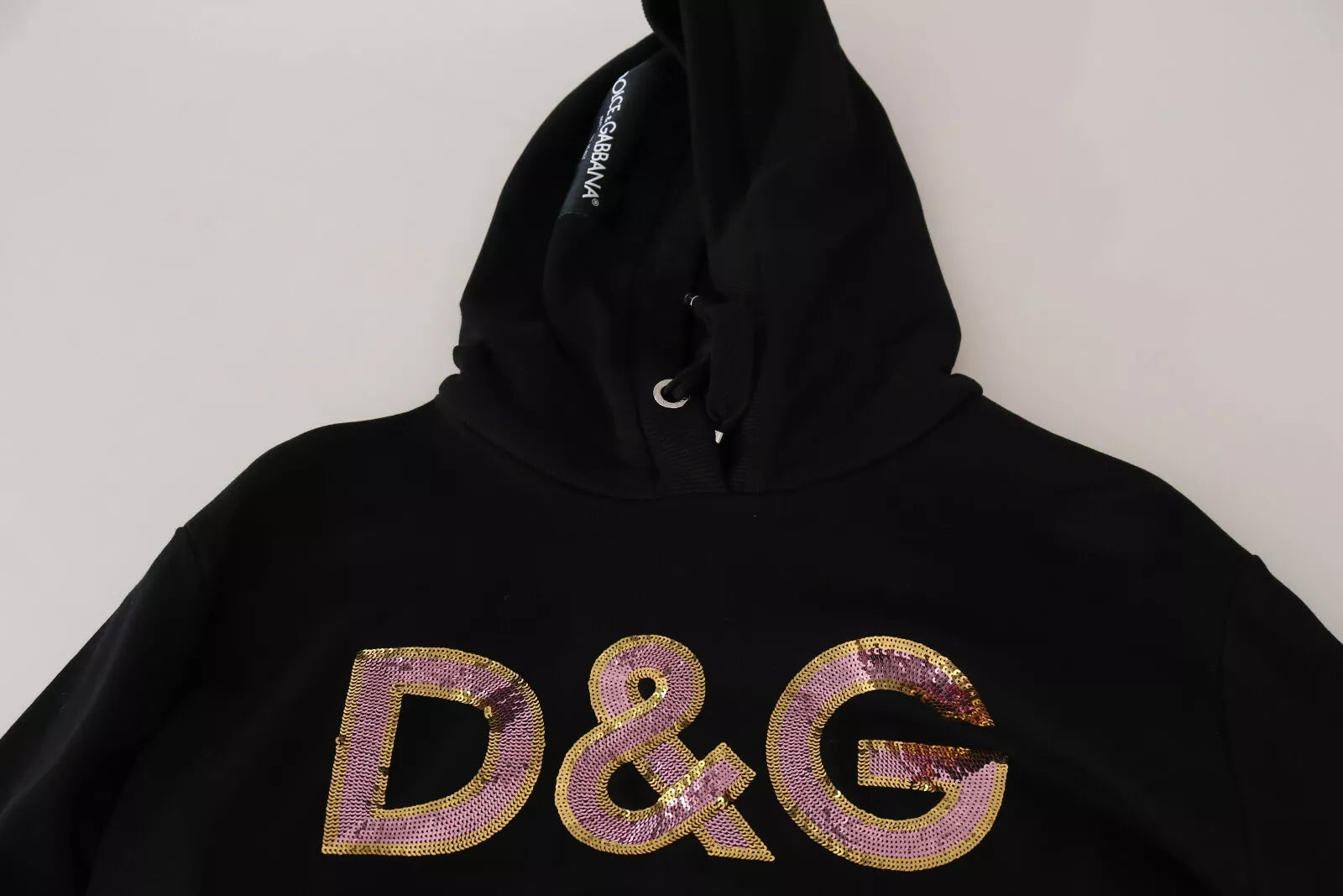 Indulge in the exquisite Dolce & Gabbana DG Sequined Hooded Pullover Sweater, a blend of luxurious cotton and dazzling sequins, embodying Italian craftsmanship and timeless allure.