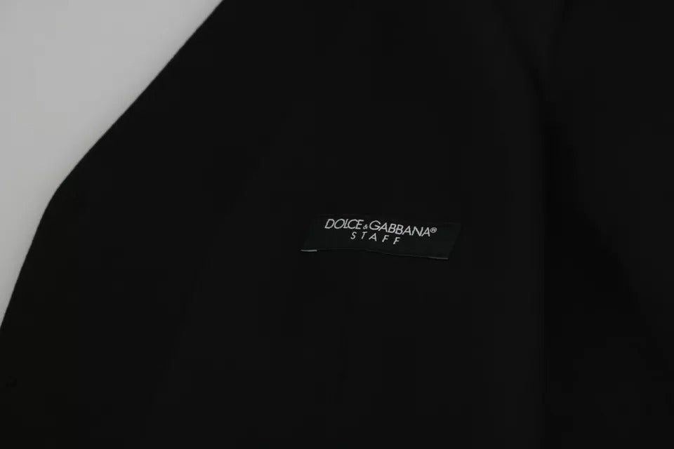 Elevate your wardrobe with the Dolce & Gabbana Black Wool Stretch Waistcoat, a masterpiece of Italian craftsmanship that embodies luxury and timeless elegance for discerning tastes.