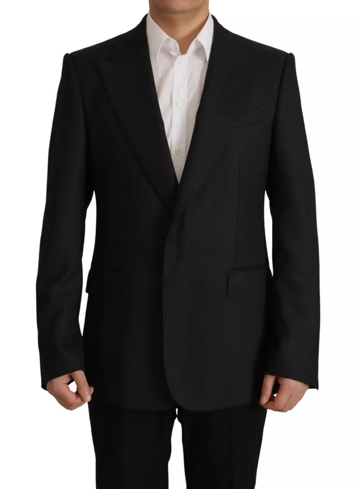 Elevate your wardrobe with the Dolce & Gabbana Black Polyester Single Breasted Blazer, a timeless piece of exquisite Italian craftsmanship that embodies luxury and sophistication.