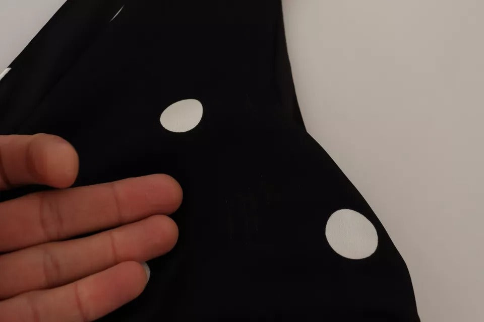 Experience the allure of the Dolce & Gabbana Black Silk Polka Dots V-neck Sheath Midi Dress, a masterpiece of Italian craftsmanship that embodies timeless elegance and sophistication.