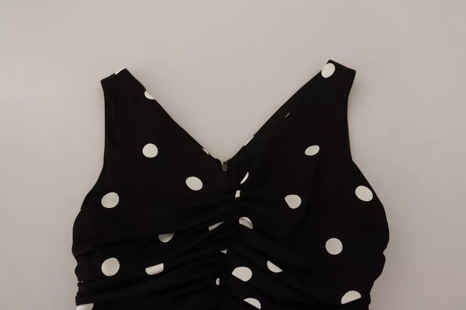 Indulge in the exquisite craftsmanship of the Dolce & Gabbana Black Silk Polka Dots V-neck Sheath Midi Dress, a timeless piece that embodies elegance and sophistication for every occasion.