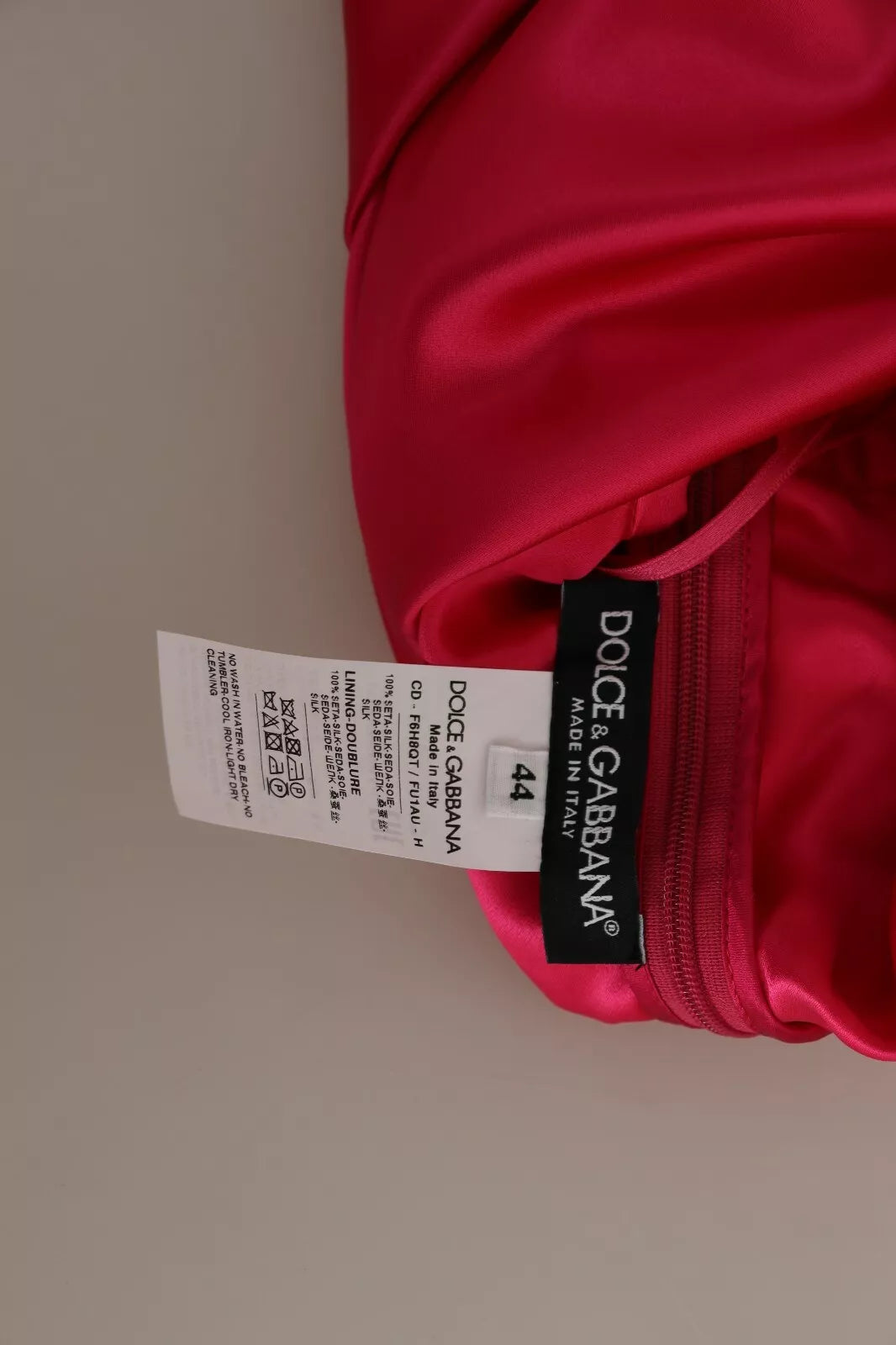 Indulge in the exquisite allure of the Dolce & Gabbana Fuchsia Fitted Cut One Shoulder Midi Dress, a testament to Italian craftsmanship and timeless elegance.