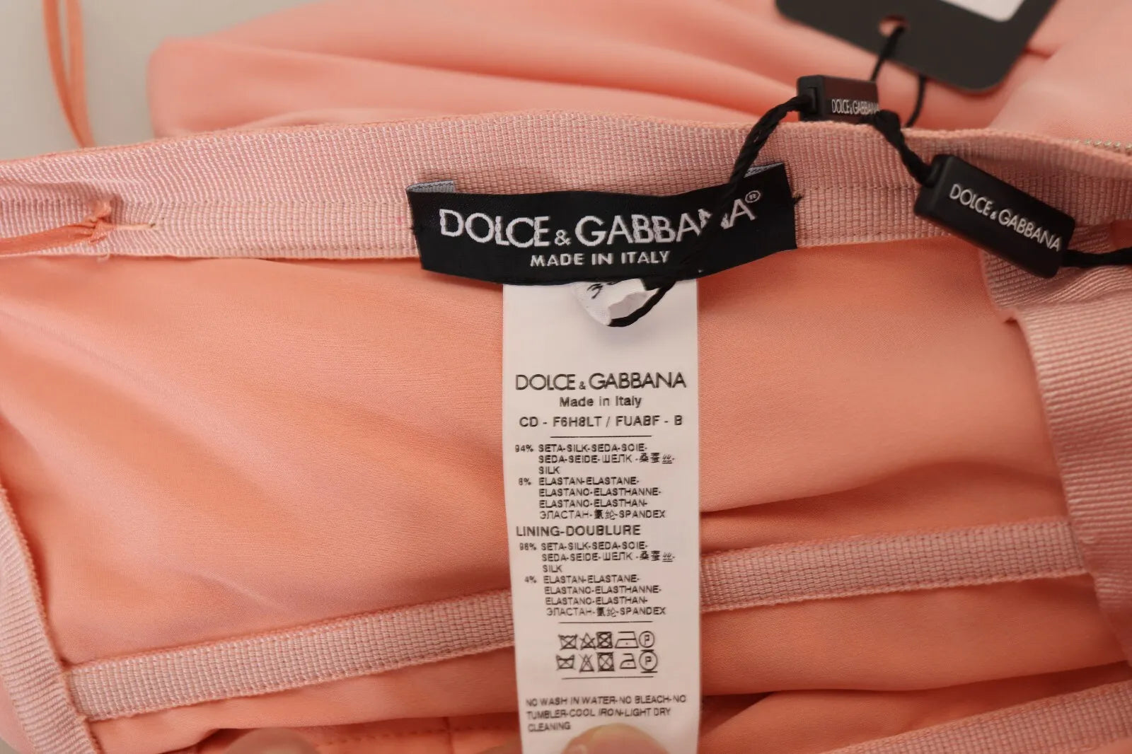 Experience the allure of the Dolce & Gabbana Pink Silk Stretch Strapless Sheath Midi Dress, where exquisite Italian craftsmanship meets luxurious silk for timeless elegance.