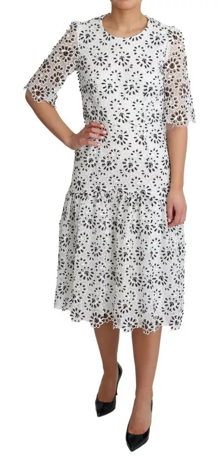 Elevate your wardrobe with the Dolce & Gabbana White Cutout Design A-line Midi Dress, a masterpiece of Italian craftsmanship, blending luxurious materials for timeless elegance.