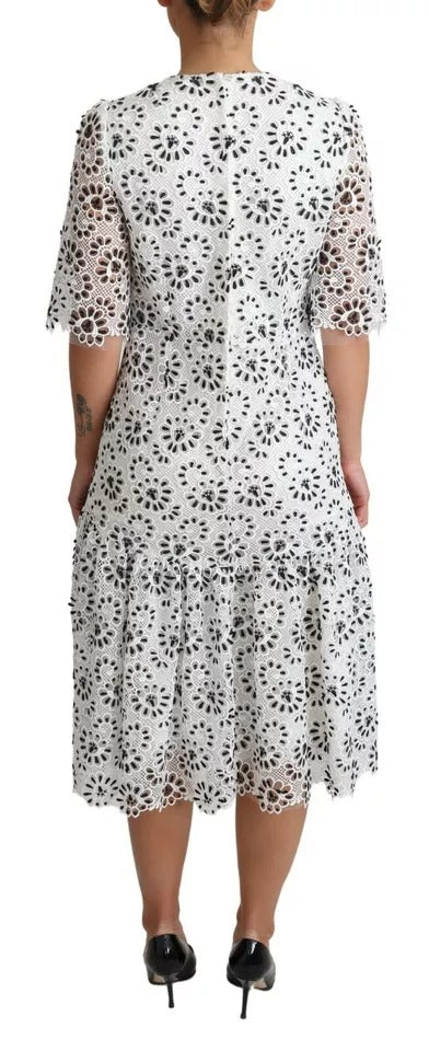 Indulge in the exquisite allure of the Dolce & Gabbana White Cutout Design A-line Midi Dress, crafted in Italy from luxurious materials, embodying timeless sophistication and elegance.