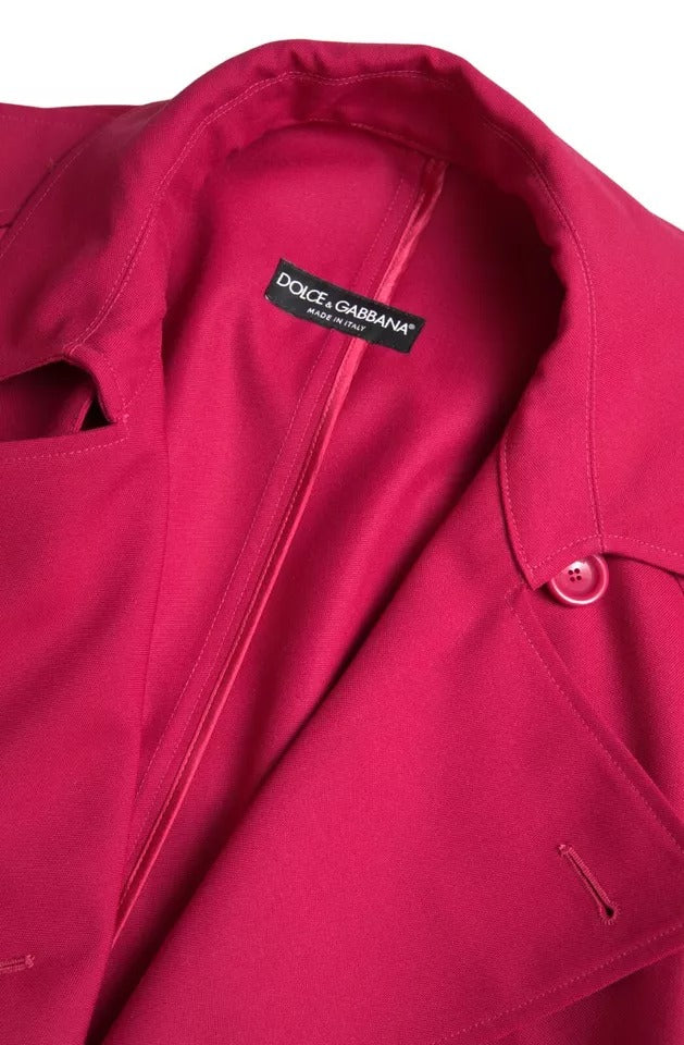 Indulge in the exquisite Dolce & Gabbana Dark Pink Double Breasted Trench Coat, a luxurious blend of polyester and virgin wool, crafted in Italy for timeless elegance and sophistication.