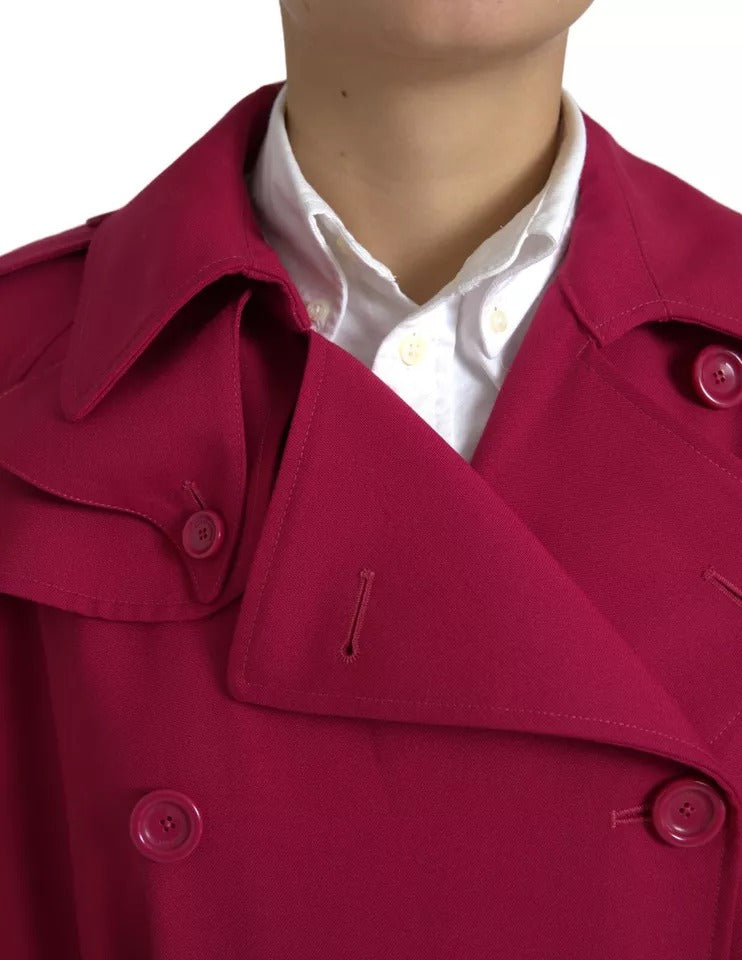 Indulge in the exquisite Dolce & Gabbana Dark Pink Double Breasted Trench Coat, a luxurious blend of polyester and virgin wool, crafted in Italy for timeless elegance and effortless sophistication.
