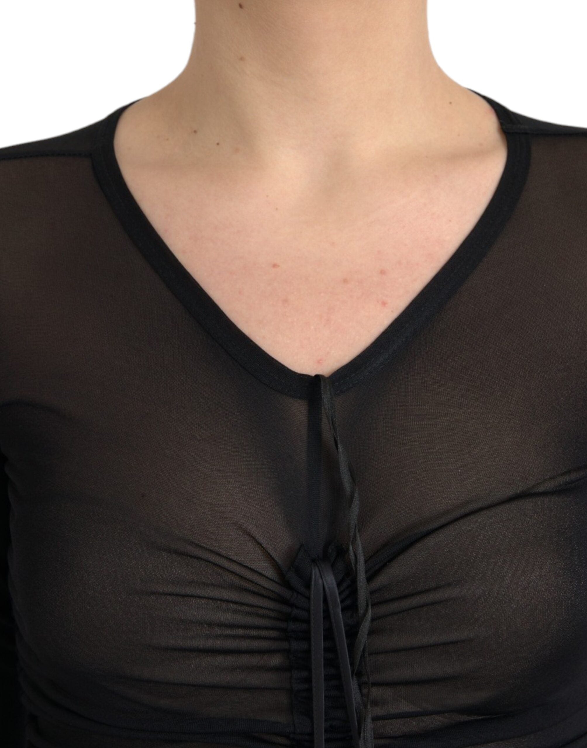 Experience the allure of the Dolce & Gabbana Black Sheer Bodycon Sheath Midi Dress, crafted from a luxurious silk blend, embodying timeless sophistication for the discerning individual.