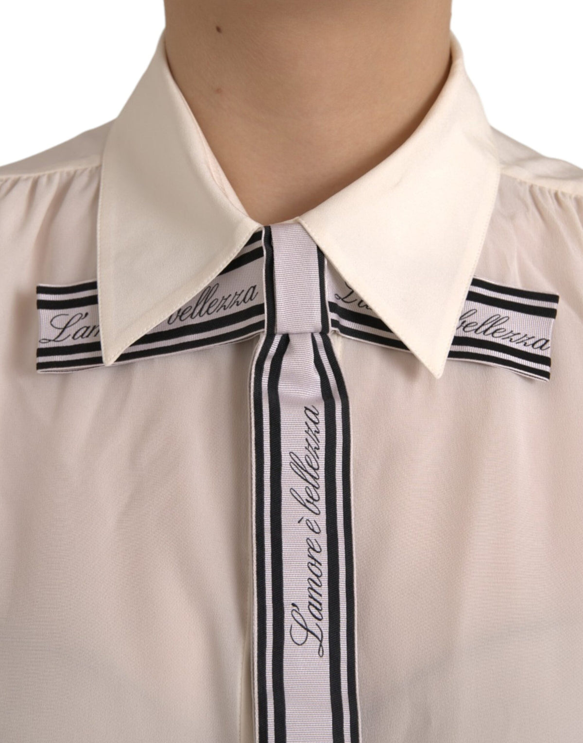 Elevate your elegance with the Dolce & Gabbana Off White Long Sleeve Button Down Blouse, crafted from luxurious silk, embodying timeless sophistication and exquisite Italian craftsmanship.