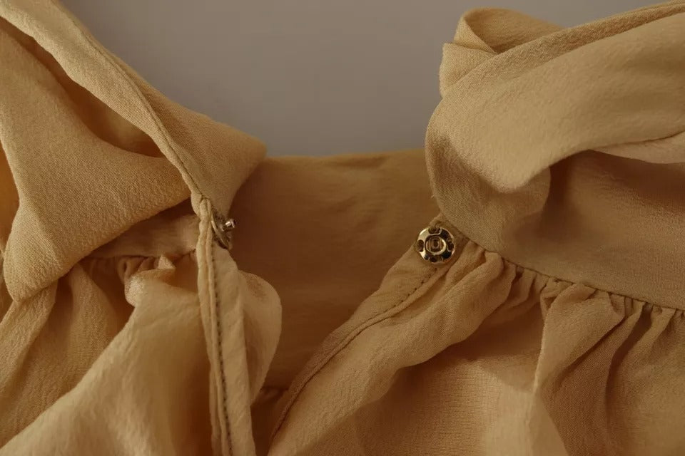 Indulge in the exquisite Dolce & Gabbana Mustard Ascot Collar Silk Blouse, a timeless piece that embodies luxury and sophistication for the discerning individual.
