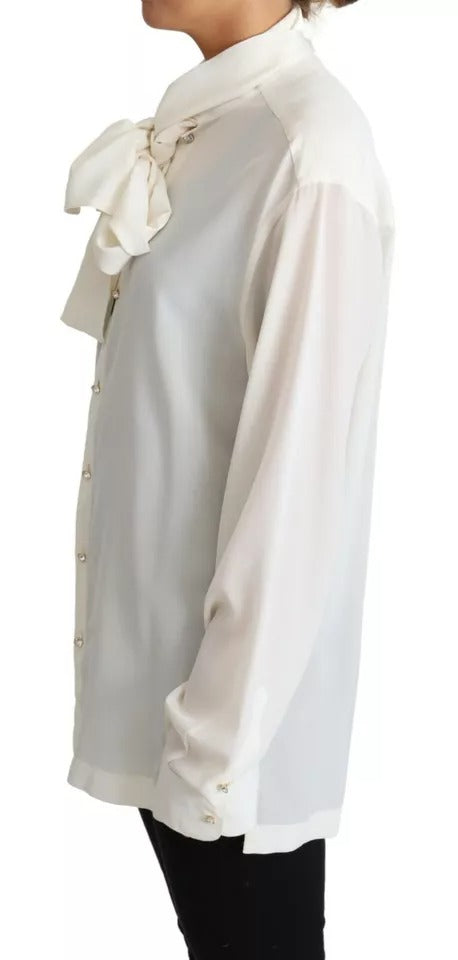 Indulge in the exquisite Dolce & Gabbana White Blouse, a 100% silk masterpiece that embodies timeless elegance and luxurious allure for the discerning individual.
