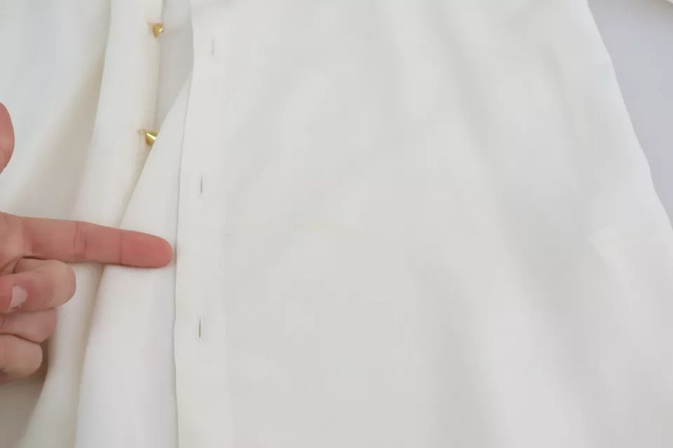 Elevate your wardrobe with the Dolce & Gabbana White Blouse, a silk masterpiece that embodies timeless elegance and luxurious allure for the discerning individual.