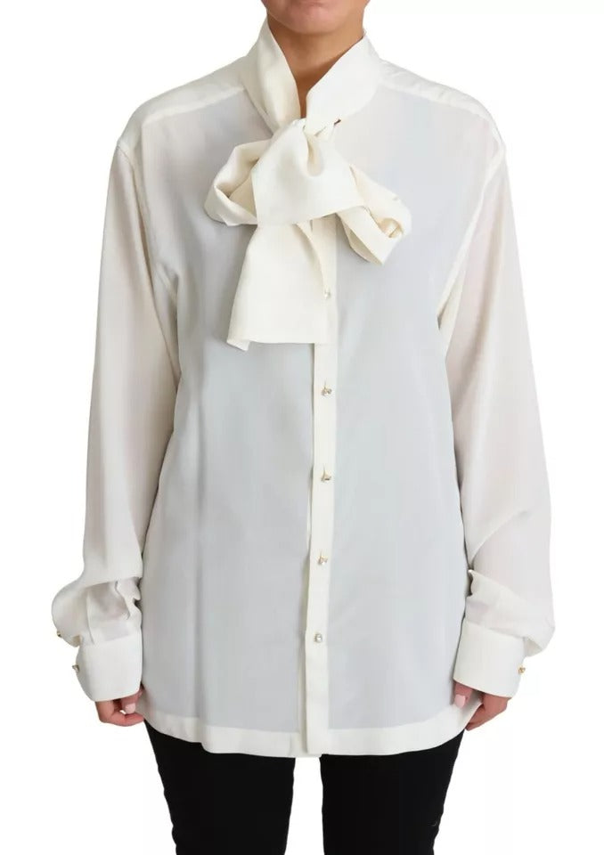 Indulge in the exquisite Dolce & Gabbana White Blouse, a 100% silk masterpiece that embodies timeless elegance and luxurious allure for the discerning individual.
