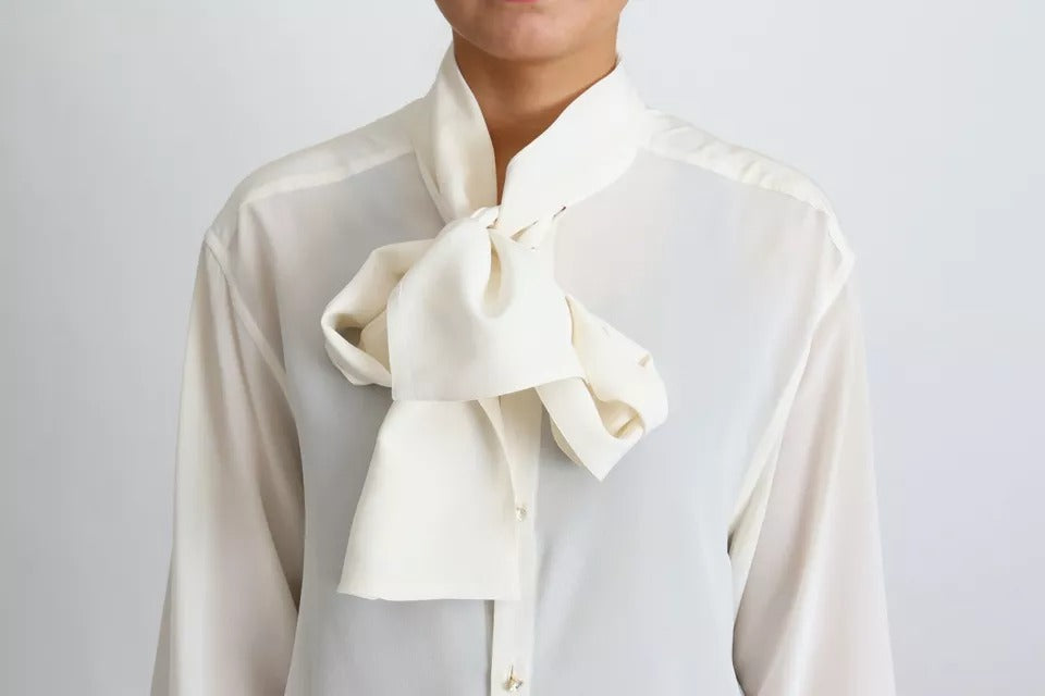 Elevate your elegance with the Dolce & Gabbana White Blouse, a silk masterpiece that embodies timeless luxury and sophistication for the discerning individual.