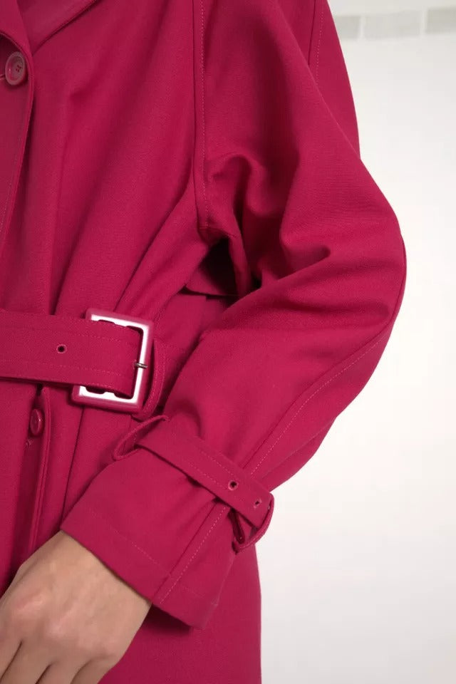 Experience the exquisite Dolce & Gabbana Dark Pink Double Breasted Trench Coat, a luxurious blend of 55% polyester and 45% virgin wool, embodying timeless elegance and sophisticated craftsmanship.