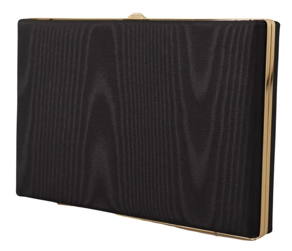 Discover the exquisite Dolce & Gabbana Black Silk Gold Frame Clutch, a luxurious blend of silk and leather, embodying timeless elegance for the discerning individual.
