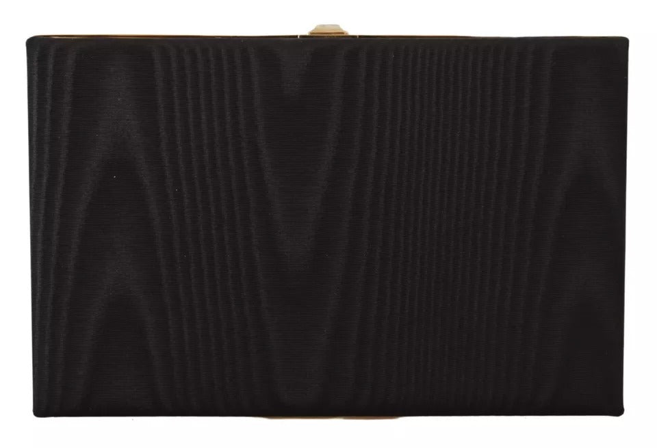 Indulge in the exquisite allure of the Dolce & Gabbana Black Silk Gold Frame Clutch, a testament to Italian craftsmanship and timeless elegance, perfect for any sophisticated occasion.