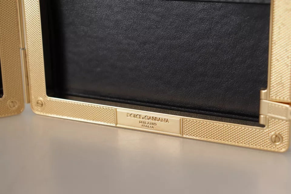 Indulge in the exquisite Dolce & Gabbana Black Silk Gold Frame Clutch, a timeless accessory crafted from luxurious silk and leather, perfect for elevating any evening ensemble.