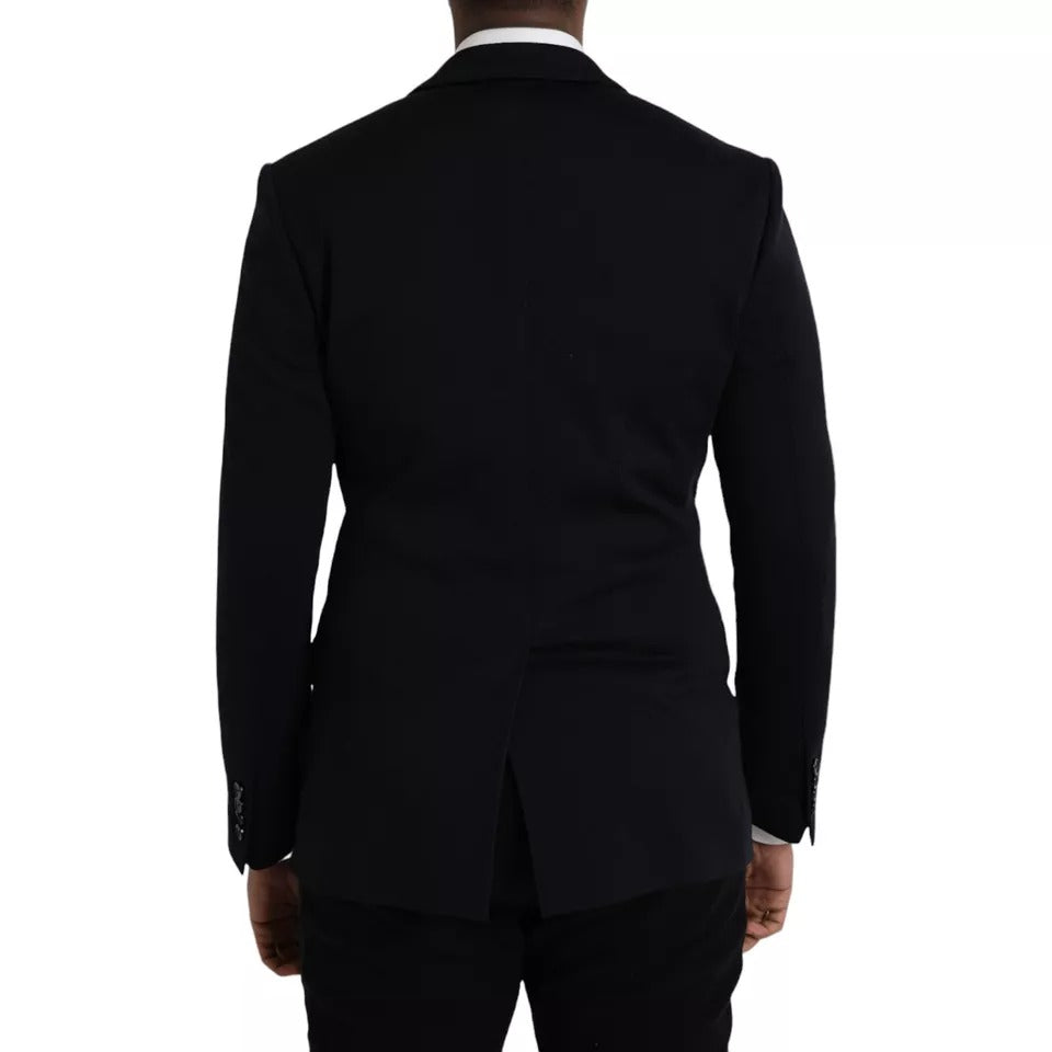 Elevate your wardrobe with the Dolce & Gabbana Blue Wool Notch Blazer, a masterpiece of Italian craftsmanship blending luxurious materials for the discerning individual.