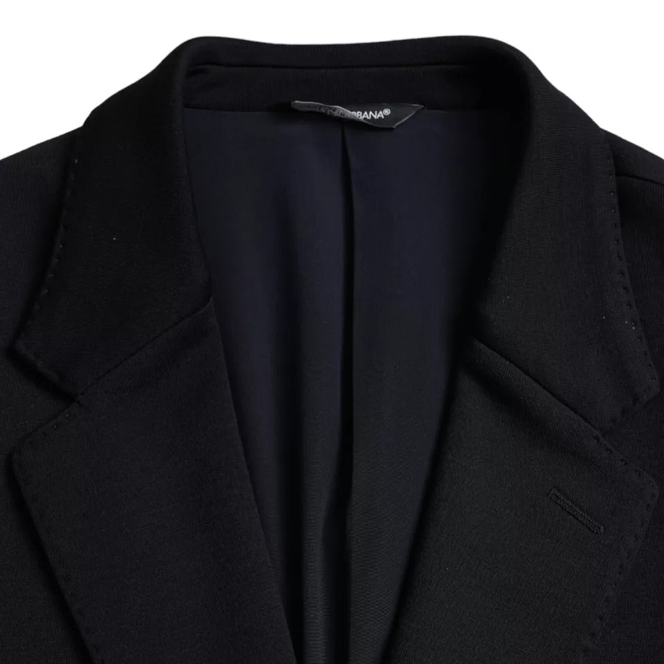 Elevate your wardrobe with the Dolce & Gabbana Blue Wool Notch Single Breasted Coat Blazer, a masterpiece of Italian craftsmanship blending luxurious virgin wool and silk for timeless sophistication.