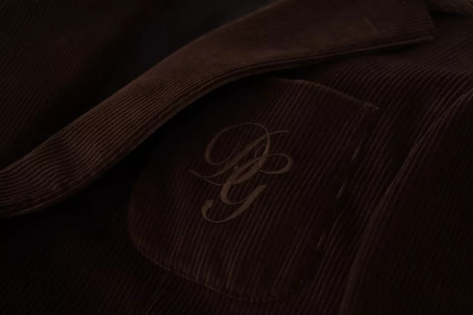 Discover the Dolce & Gabbana Brown Corduroy Slim Fit Coat, a masterpiece of Italian craftsmanship, blending luxurious materials with timeless elegance for the discerning individual.