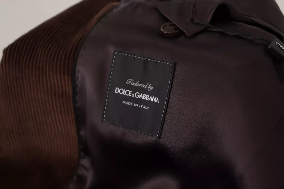 Elevate your wardrobe with the Dolce & Gabbana Brown Corduroy Slim Fit Coat, a masterpiece of Italian craftsmanship that embodies timeless elegance and sophistication.