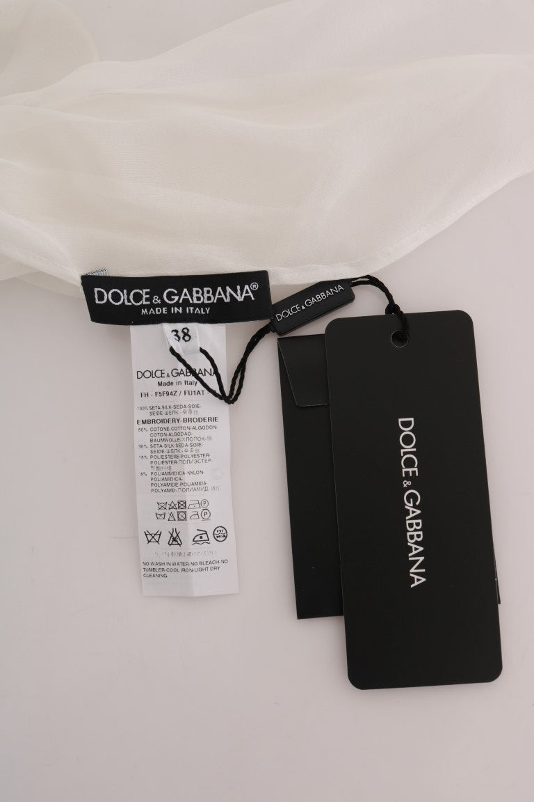 Indulge in the timeless elegance of the Dolce & Gabbana White Daisy Applique Silk Shirt, crafted in Italy from sumptuous silk, embodying luxury and sophistication for any occasion.