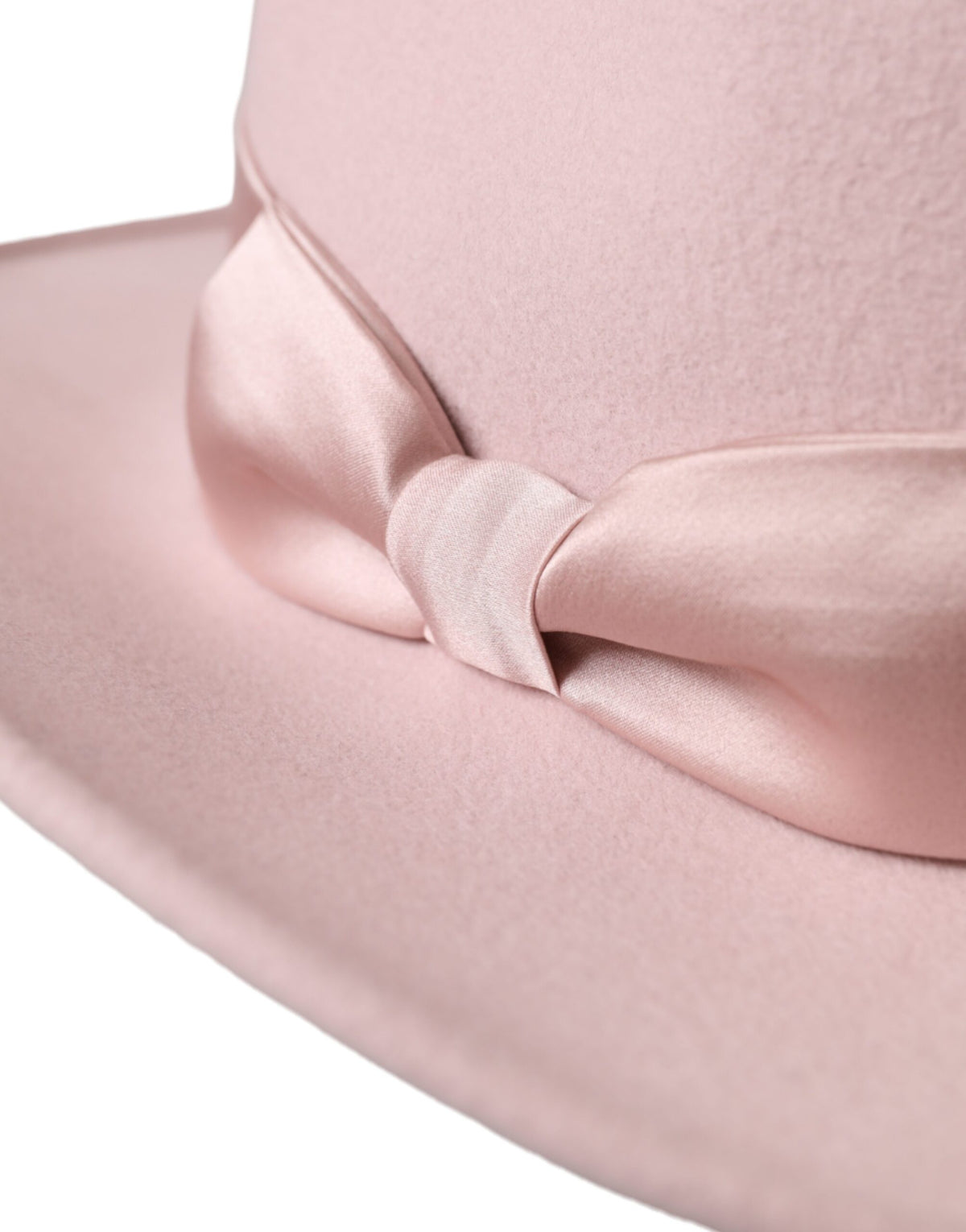 Discover the Dolce & Gabbana Pink Rabbit Fedora Trilby, a luxurious blend of rabbit fur and silk, expertly crafted in Italy for the discerning individual seeking timeless elegance.
