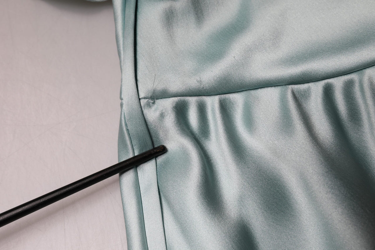 Experience the allure of the Dolce & Gabbana Mint Green Silk Fit Cut One Shoulder Dress, a timeless masterpiece crafted in Italy, embodying sophisticated elegance and luxurious craftsmanship.