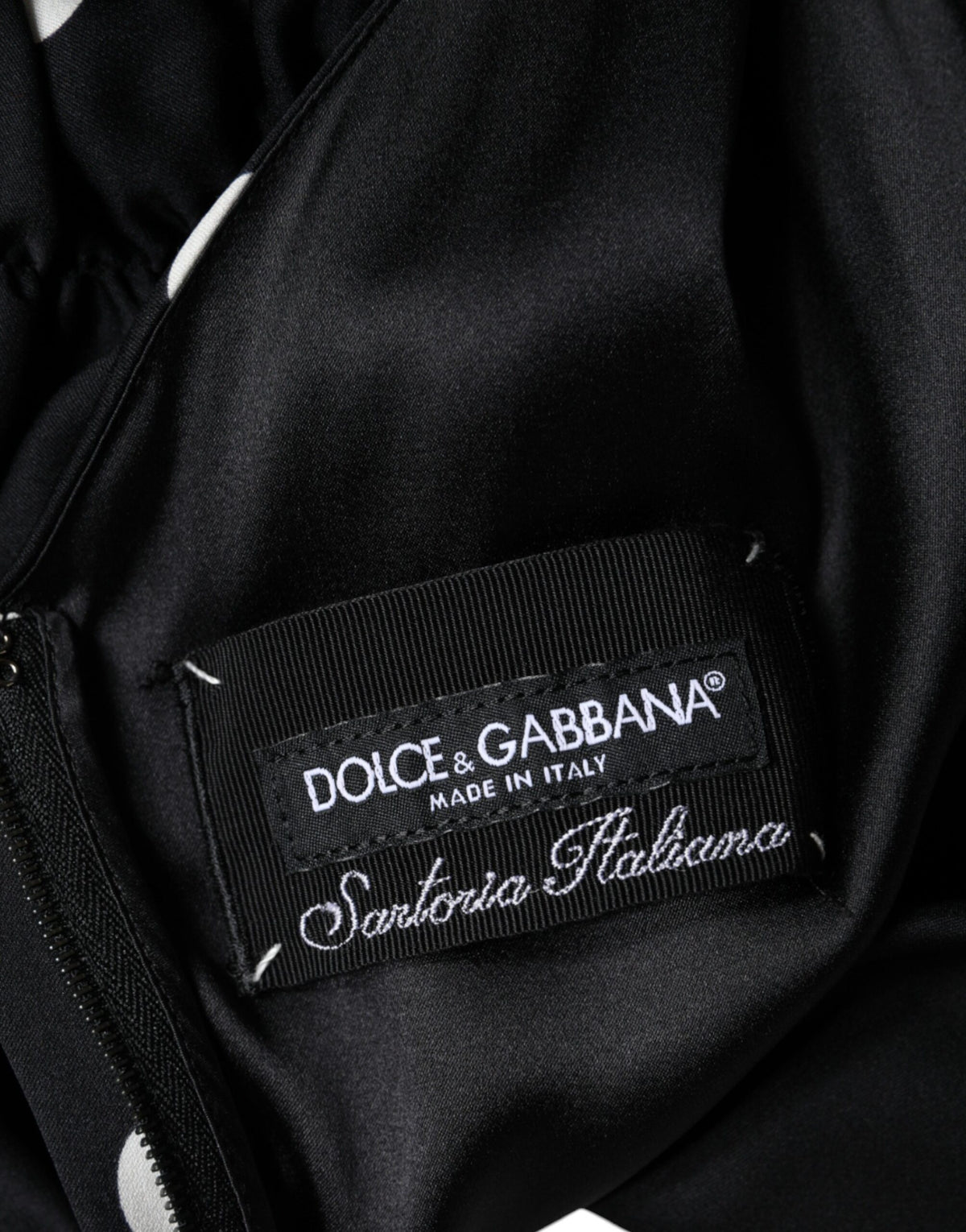 Elevate your elegance with the Dolce & Gabbana Black Silk Polka Dot V-neck Tassel Midi Dress, a masterpiece of Italian craftsmanship that embodies timeless luxury and allure.